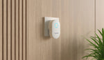 Reolink Chime, Best Companion for Reolink Video Doorbell plugged into mains power inside a home on wooden effect wall.