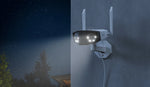 Reolink Duo 2 WiFi 4K 8MP Wi-Fi 6 Plug-in Camera with 180° Panorama mounted on external wall at night emitting white spotlight