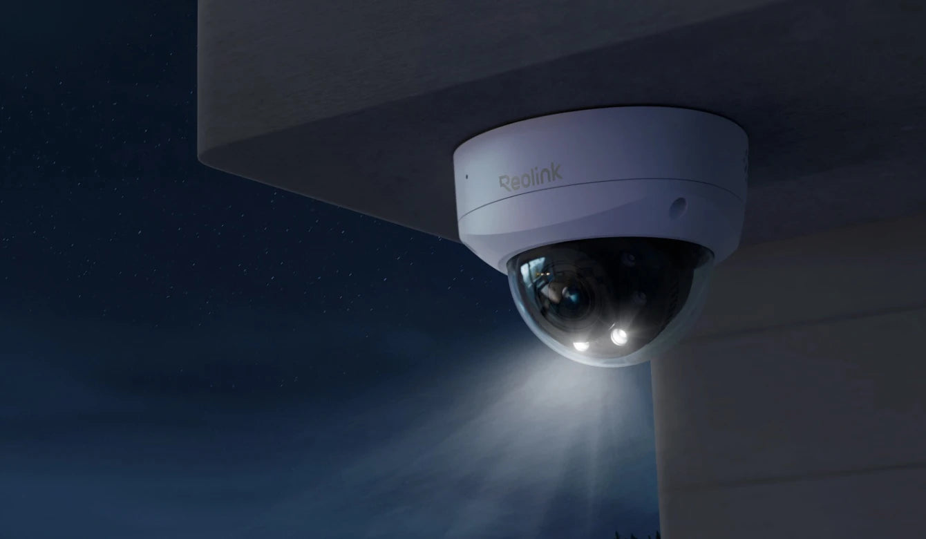 Reolink RLC-843A Smart 4K PoE IK10 Camera with 5X Optical Zoom on front porch at night emitting spotlight