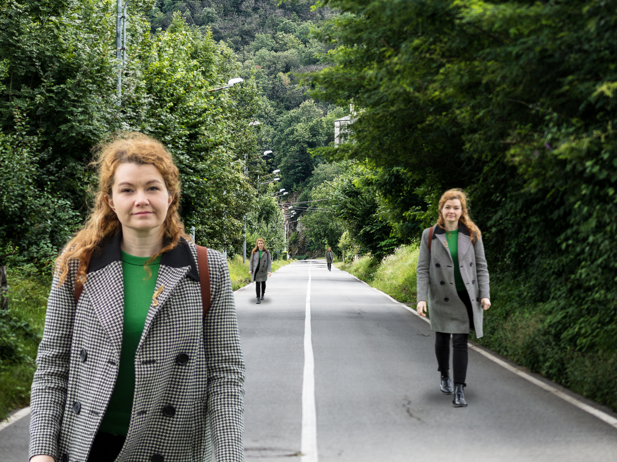 Woman walking on a road appearing at different distances at the same time with greenery on both sides