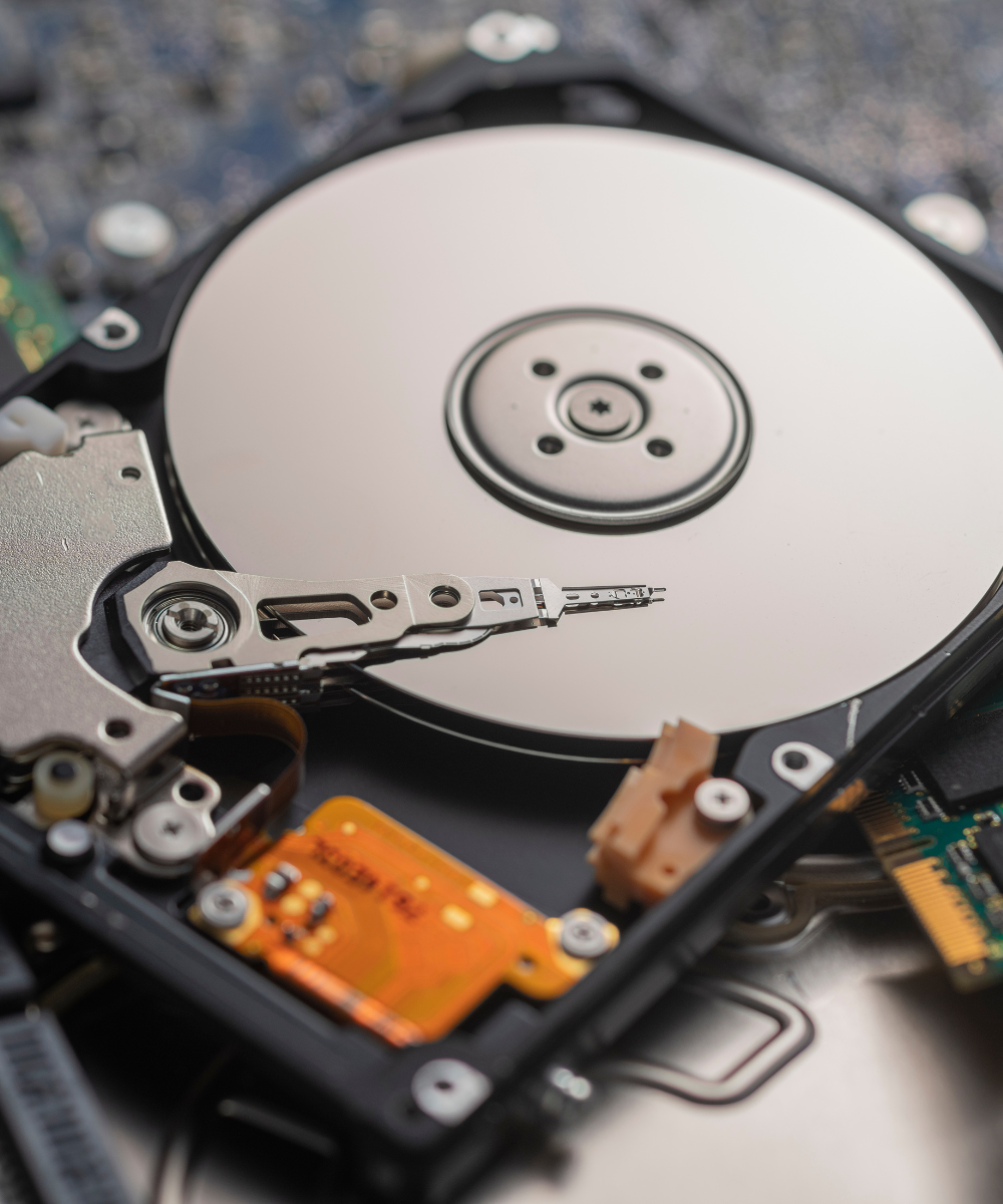 Close-up of a hard disk drive with metallic and electronic components.