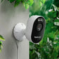 Reolink Lumus Pro Outdoor security camera mounted on a wall with greenery in the background in the rain