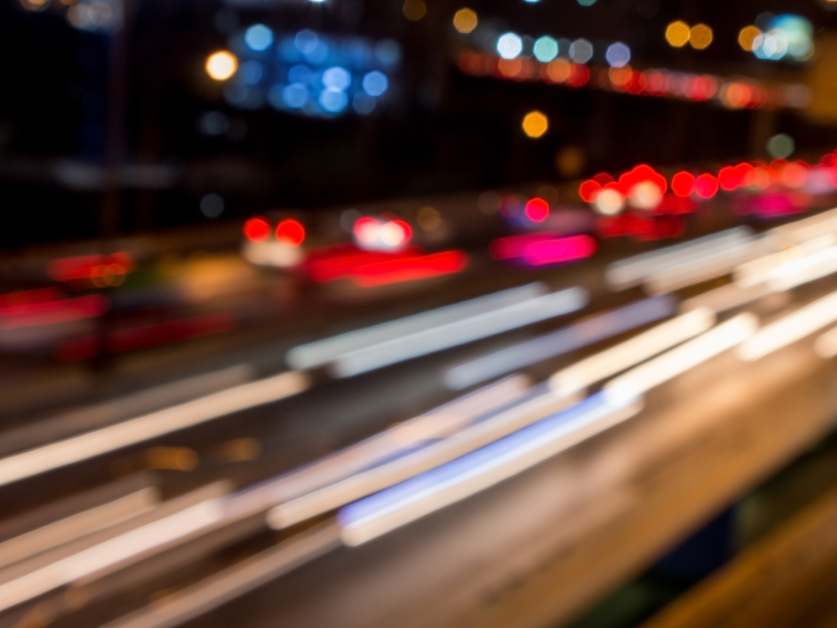Blurred city street at night with colorful lights
