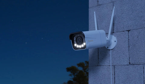 RLC-811WA 4K Wifi 6 Camera on brick wall at night time with white light mode activated