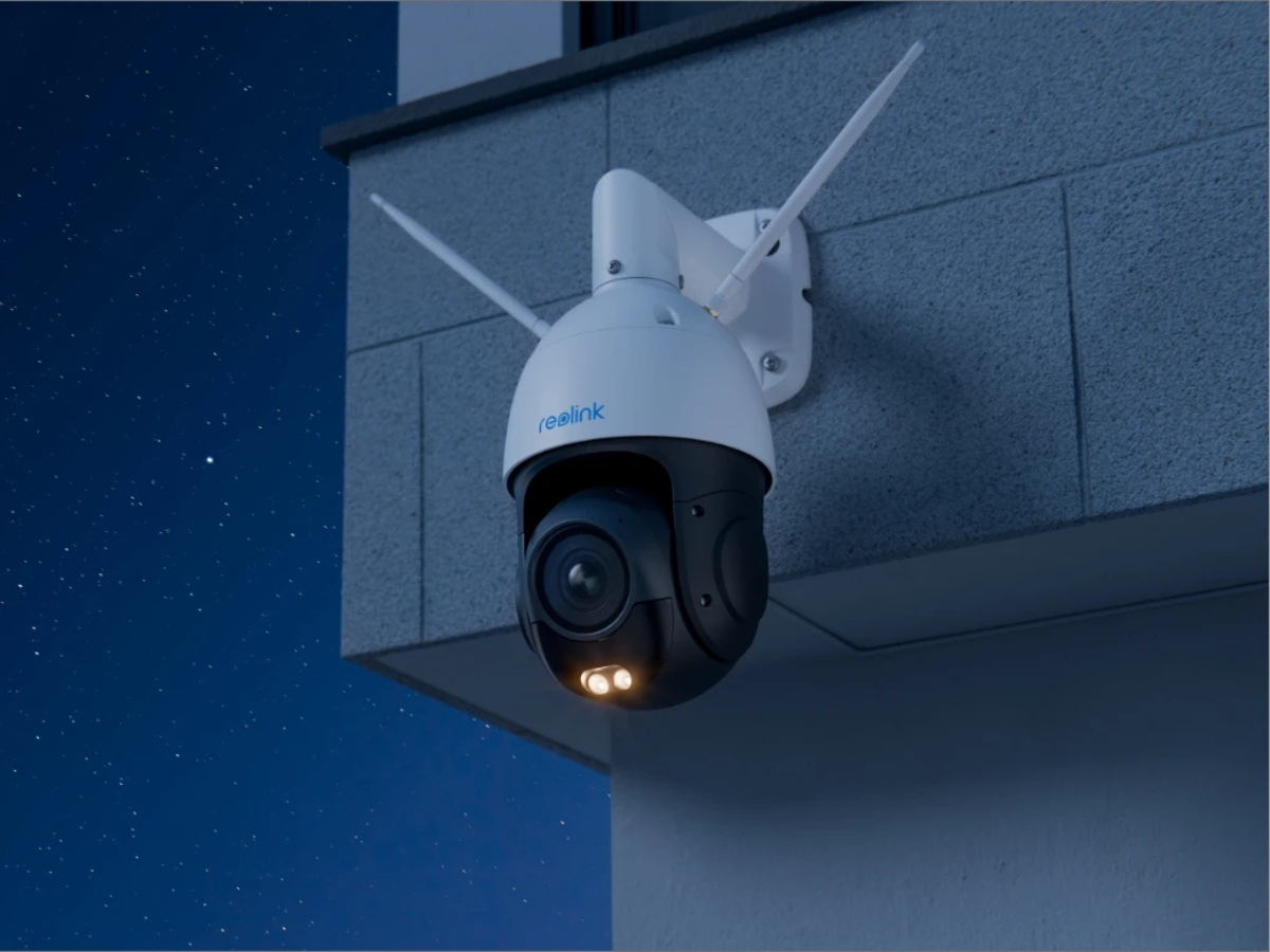 Security camera with antenna on a building exterior at night