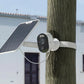 Reolink Argus 3E 3MP Wireless Solar & Battery Powered Security Camera with Smart Detection strapped to tree with solar panel