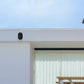 Reolink Argus 3 Ultra 4K Battery/Solar-Powered Standalone WiFi Camera with Color Night Vision on external wall with solar panel mounted to the roof 