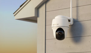 Reolink Argus PT Ultra 4K 8MP Wireless Pan & Tilt Standalone Solar/Battery Camera with Spotlights mounted on external wall and sunset