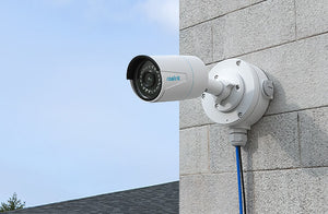 Reolink B10 Junction Box white attached to camera, on external wall