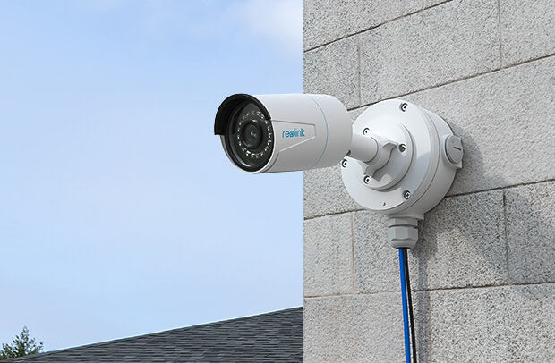 Reolink B10 Junction Box white attached to camera, on external wall 