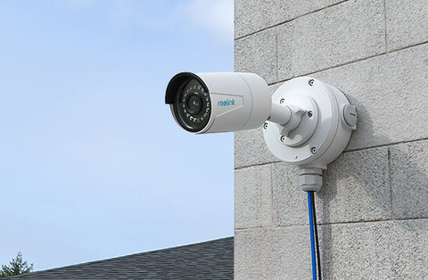 Reolink B10 Junction Box white attached to camera, on external wall 