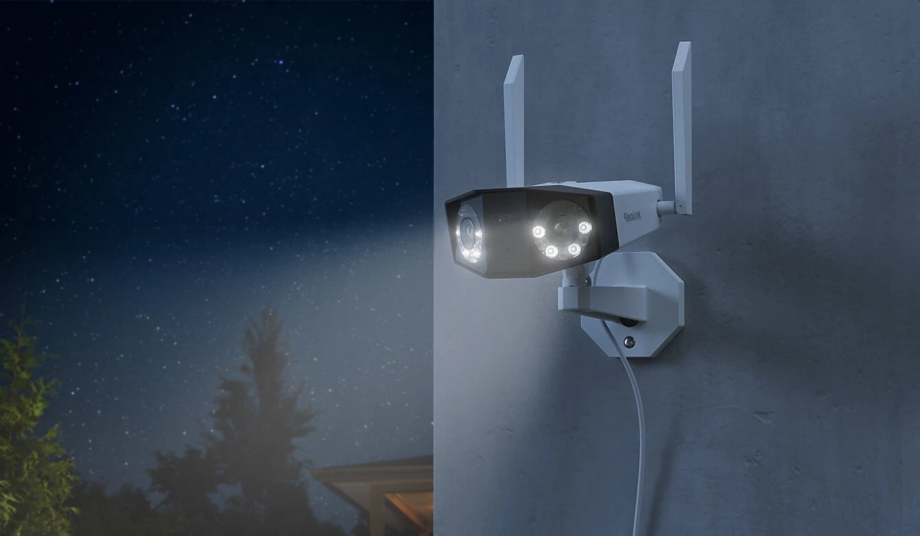 Reolink Duo 2 WiFi 4K 8MP Wi-Fi 6 Plug-in Camera with 180° Panorama mounted on external wall at night emitting white spotlight