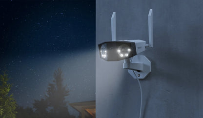 Reolink Duo 2 WiFi 4K 8MP Wi-Fi 6 Plug-in Camera with 180° Panorama mounted on external wall at night emitting white spotlight