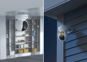 Reolink E1 Outdoor SE mounted on internal ceiling and external wall at night emitting warm spotlight