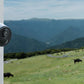Reolink Go Plus Smart 4MP 4G Battery Camera viewing cow field with blue highlight graphic for rechargeable battery