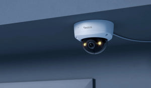 Reolink RLC-540A 5MP IK10 Vandal-Proof PoE Camera mounted on internal ceiling emitting warm spotlight