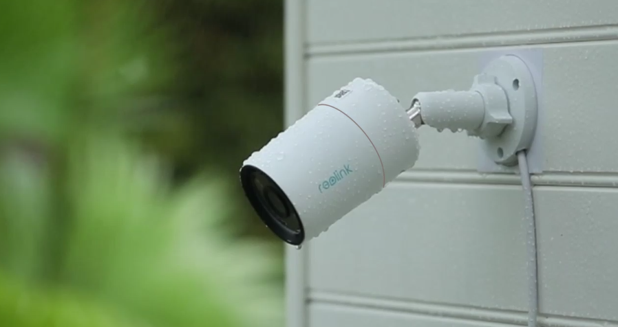 Reolink RLC-1212A Intelligent 12MP PoE Camera with Powerful Spotlight displaying IP67 weatherproofing in he rain