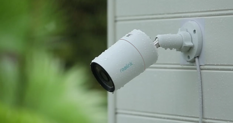 Reolink RLC-1212A Intelligent 12MP PoE Camera with Powerful Spotlight displaying IP67 weatherproofing in he rain