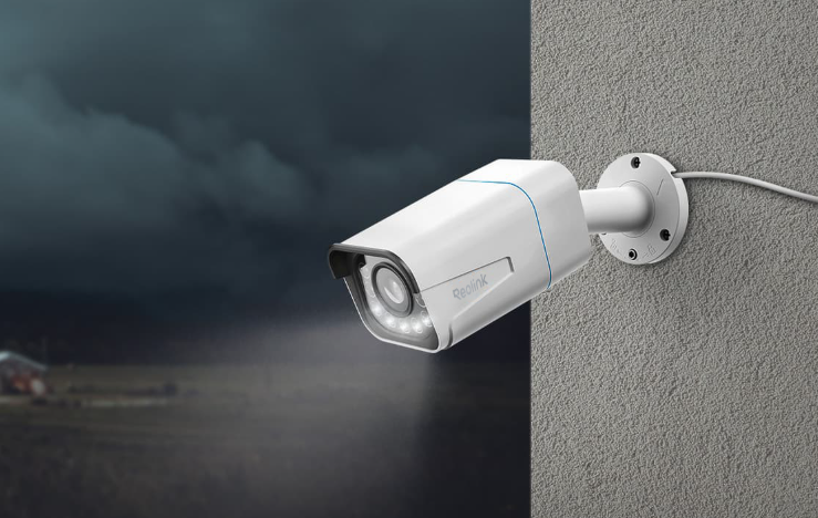 Reolink RLC-811A 4K Smart PoE Camera with Spotlight & Color Night Vision on external wall at night emitting spotlight. 