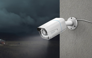 Reolink RLC-811A 4K Smart PoE Camera with Spotlight & Color Night Vision on external wall at night emitting spotlight. 