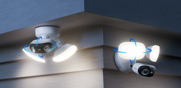 Two reolink elite wifi security cameras with flood lights mounted on a wall corner with adjustable arrow graphics.