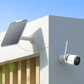 Solar panel and reolink altas security camera on a building exterior with clear sky.