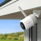 Reolink altas security camera attached to an exterior ceiling with clear sky background