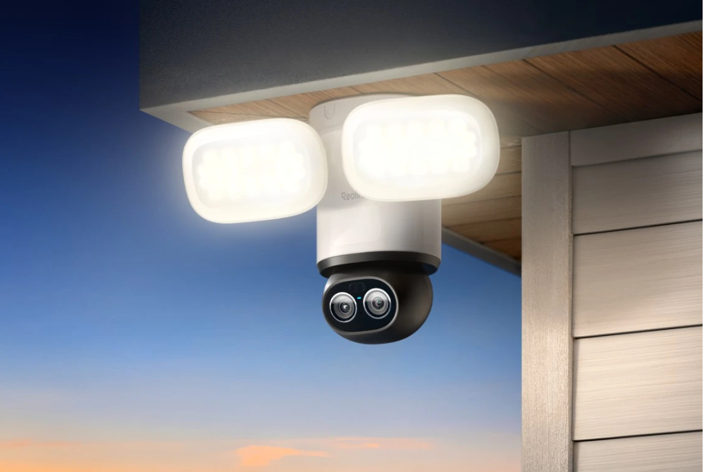 Reolink Trackmix Floodlight hardwired wifi camera on eaves of wooden building 