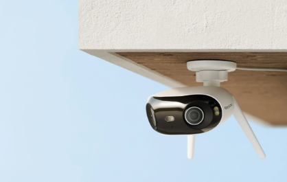 Reolink Elite WIFI Smart home security camera attached to a ceiling with a clear blue sky background