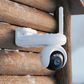 Reolink Altas Go PT White security camera on a wooden surface with a snowy background