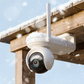 Reolink Altas Go PT Security camera on a wooden structure with snowfall in the background