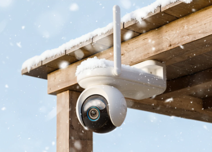 Reolink Altas Go PT Security camera on a wooden structure with snowfall in the background