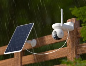Reolink Altas Go PT CCTV camera with solar panel on a wooden post outdoors in the rain