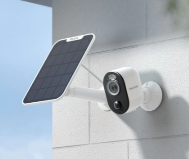white Reolink Camera mounted on a wall next to a white solar panel