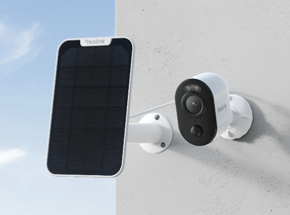 white Reolink CCTV Camera mounted on a wall next to a white solar panel